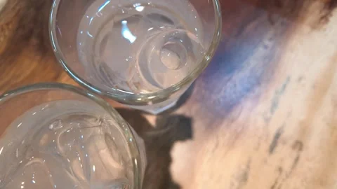 Top View of Cold Water Glasses with Ice Cubes on Wooden Table Stock Footage 342895903