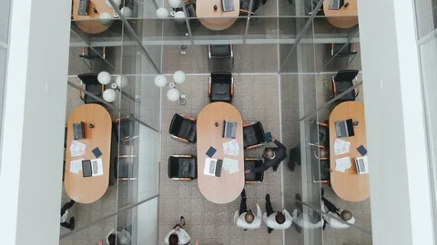 Top view. Colleagues office workers enter office space meeting room and sit at Stock Footage 122917838