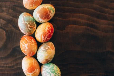 Top view of color easter eggs differen patterns. Line of eggs on wooden 스톡 사진