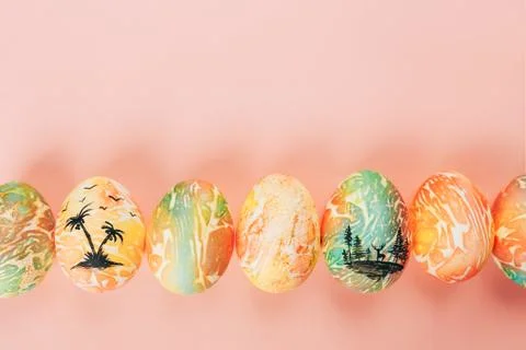 Top view of color easter eggs differen patterns. Line of eggs on yellow 스톡 사진