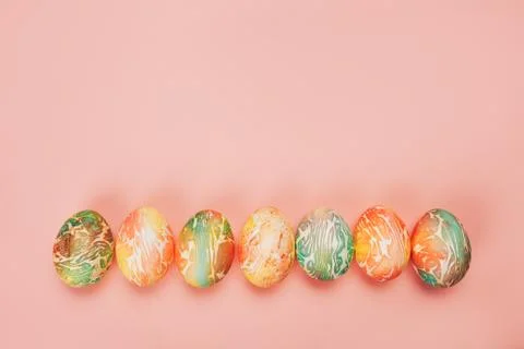 Top view of color easter eggs differen patterns. Line of eggs on yellow Stock-Fotos