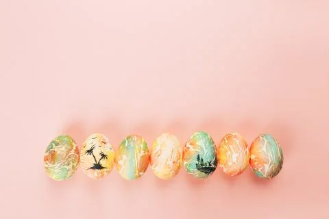 Top view of color easter eggs differen patterns. Line of eggs on yellow 스톡 사진