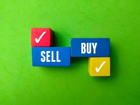 Top view colord cube with text SELL BUY on green background. Stock Photos