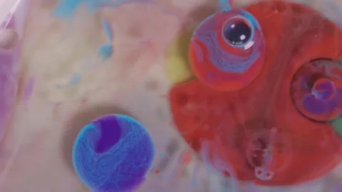 Top view of colored acrylic paint bubbles moving on milk, oil Stock Footage 252805920