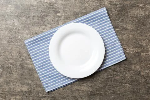 Top view on colored background empty round white plate on tablecloth for fo.. Stock Photos