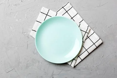 Top view on colored background empty round blue plate on tablecloth for foo.. Stock Photos