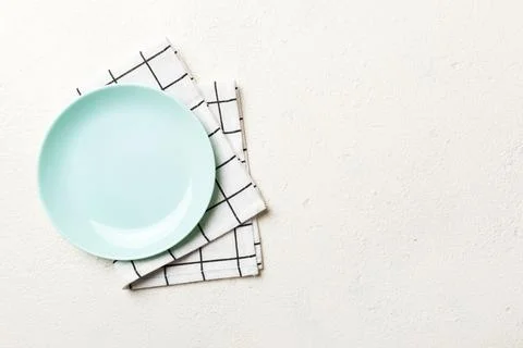Top view on colored background empty round blue plate on tablecloth for foo.. Stock Photos