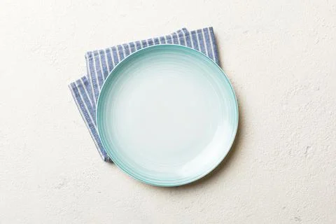 Top view on colored background empty round blue plate on tablecloth for foo.. Stock Photos