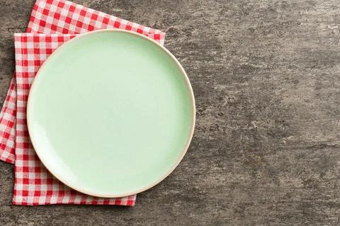 Top view on colored background empty round green plate on tablecloth for fo.. Stock Photos