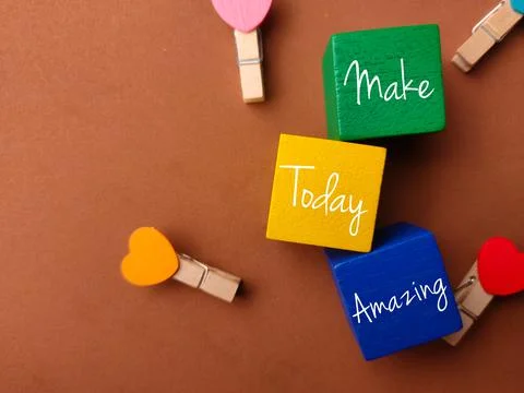 Top view colored block and wooden clips with text Make Today Amazing on a bro Stock Photos