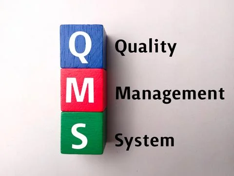 Top view colored block with text QMS quality management system Stock Photos