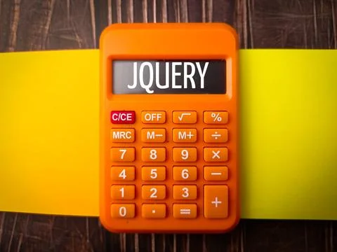 Top view colored notebook and calculator with text JQUERY Stock Photos
