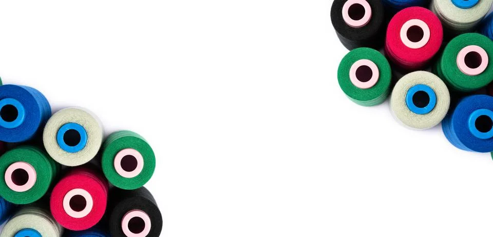 Top view of colored spools of thread on a white background with copy space. Stock-Fotos