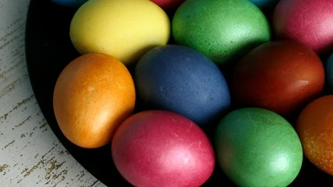 Top View Of Colorful Easter Eggs Lying On Black Plate On A Wooden Background Pan Stock Footage 126575483