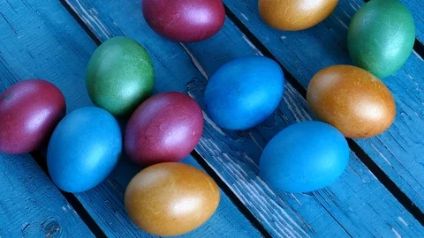 Top View Of Colorful Easter Eggs On A Blue Wooden Background. Natural Daylight.  스톡 동영상 126589418