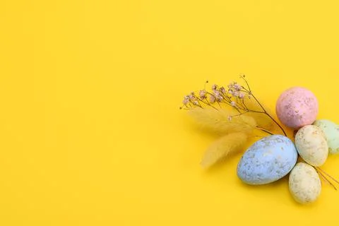 Top view of a colorful easter eggs on a yellow background. free space Stock Photos