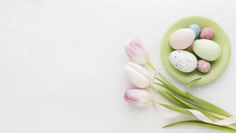 Top view colorful easter eggs plate with tulips Stock Photos