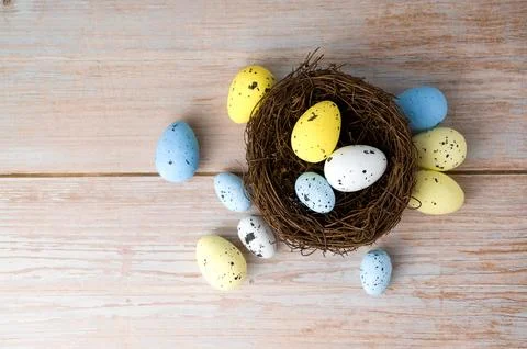 Top view on Colorful easter eggs in the nest. April holidays concept. Yello.. Stock Photos