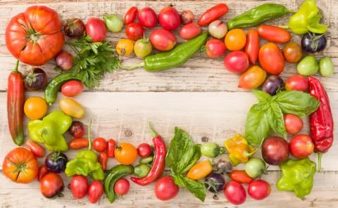 Top view on colorful frame made of organic vegetables: tomatoes, paprika, and Stock Photos