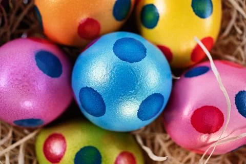 Top view of colourful Easter eggs with polka dots in a basket Stock Photos