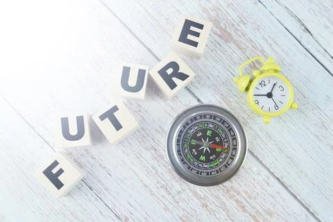 Top view of compass, clock and wooden blocks with text FUTURE Stock Photos