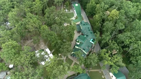 Top view of a complex of houses with a green tiled roof in the middle Stock Footage 149133434