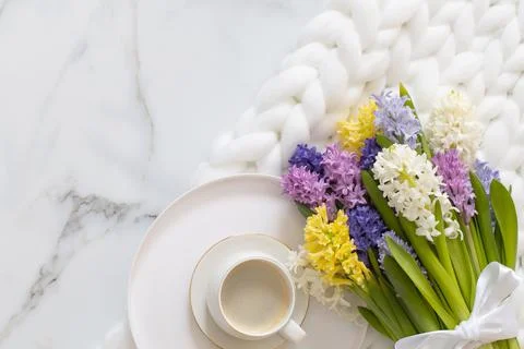 Top view composition with cup of coffee spring multicolored hyacinth on white Stock Photos