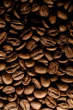 Top view on composition of dark roasted coffee beans. Can be used as background. Stock-Fotos