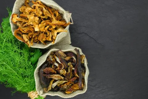 Top view composition of dry boletus and chanterelles mushrooms placed in canv Stock Photos