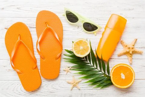 Top view composition of flip flops placed with beach accessories top view on  Stock Photos