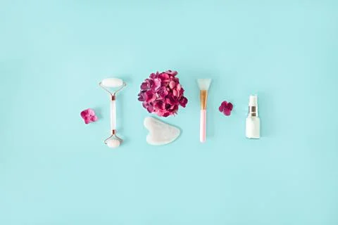 Top view composition with pink jade roller face massager, gouache scraper, brush Stock Photos
