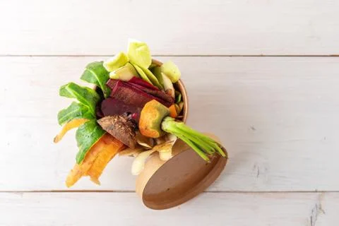 Top view compost concept, vegetable peels in cardboard biodegradable containe Stock Photos