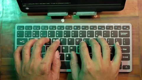Top view of computer hacker's hands typing code on a keyboard Stock Footage 280179007
