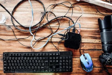 Top view of computer keyboard, mouse and digital camera on wooden table Stock Photos