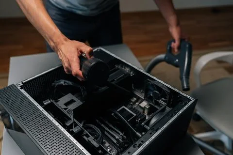 Top view of computer technician cleaning desktop computer interior with vacuum Stock Photos