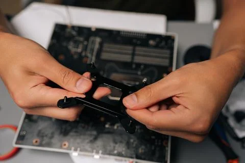 Top view of computer technician mounting CPU cooler bracket on motherboard Stock Photos