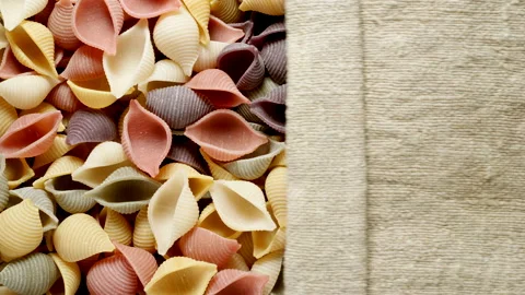 TOP VIEW: Conchiglie pasta under opening sackcloth Stock Footage 171920341