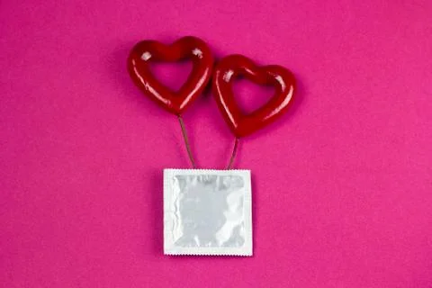 Top view condom pack and hearts Stock Photos