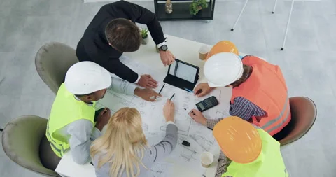 Top view of confident concentrated professional multiethnic team of builders and Stock Footage 145805935