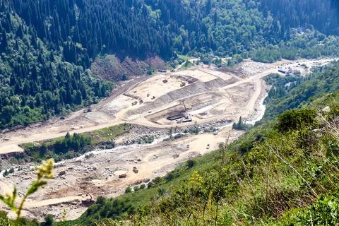 Top view of the construction of a dam on a mountain river Stock Photos