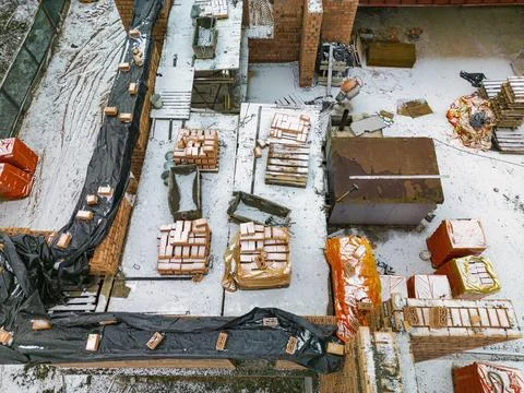Top view of the construction site. Construction of a red brick house. Buildin Photos