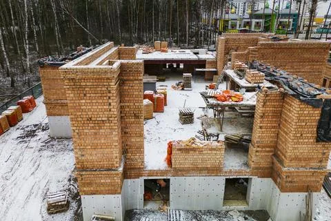 Top view of the construction site. Construction of a red brick house. Buildin Stock Photos