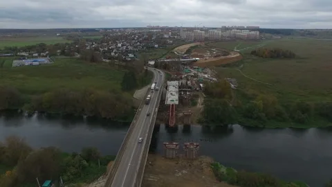 Top view of construction site. Road through the bridge going through the river Stock Footage 97785732