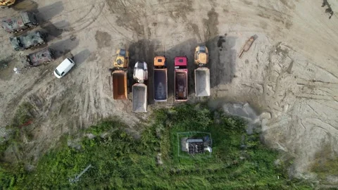 Top view of construction trucks and earthmovers at an industrial quarry site Stock Footage 347864489