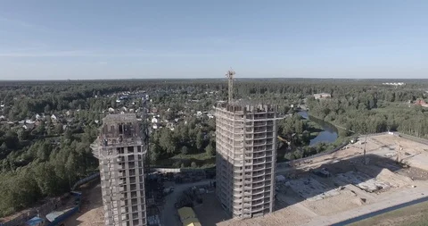 Top view of the construction of two high-rise buildings with cranes and workers Stock Footage 105080154