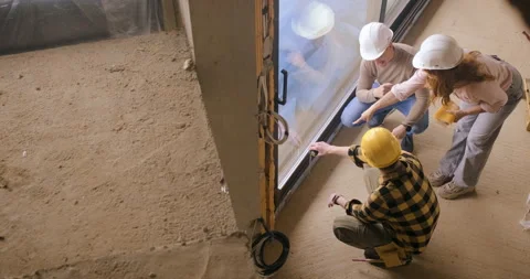 Top view of construction worker showing the progress of a house build to an.. Stock Footage 336251446