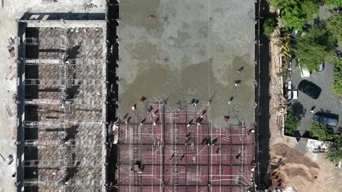 Top View of Construction Workers Laying Foundation on Industrial Building Roof Stock Footage 344477511