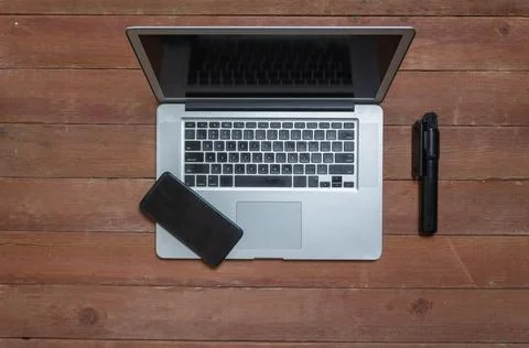 Top view of content creator desk with laptop, selfie stick and cell phone. Mo Photos
