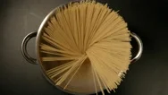 Top View: A Cook Puts Down A Spaghetti In A Steel Pot (Round) Stock Footage