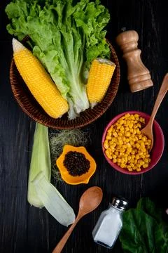 Top view of cooked corns corn seeds lettuce with corn shell and silk salt s.. Stock Photos